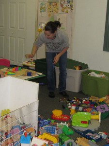 Frankie Masters, a United Way Day of Caring volunteer from Avery Dennison, sorts blocks into  piles as part of her team’s project to clean up the playroom at Forbes House.